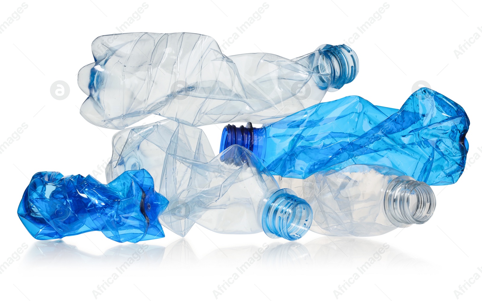 Photo of Crumpled disposable plastic bottles isolated on white