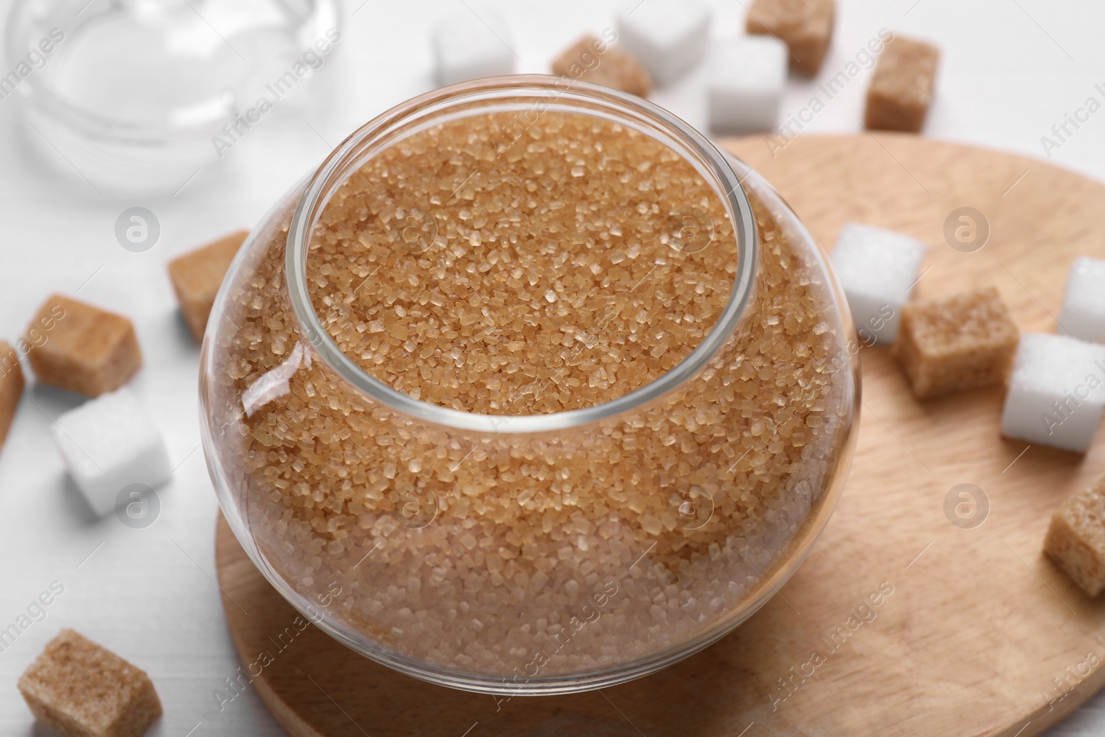 Photo of Brown sugar in glass jar on table, closeup