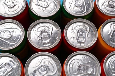 Photo of Energy drinks in wet cans, above view. Functional beverage