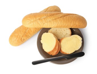 Photo of Whole and cut baguettes with fresh butter on white background, top view