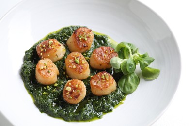 Photo of Delicious fried scallops with tasty sauce and corn salad in bowl, closeup