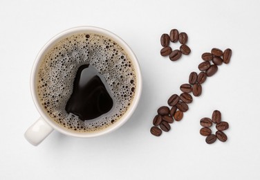 Photo of Cup of coffee and beans as percent sign on white background, top view. Decaffeinated drink
