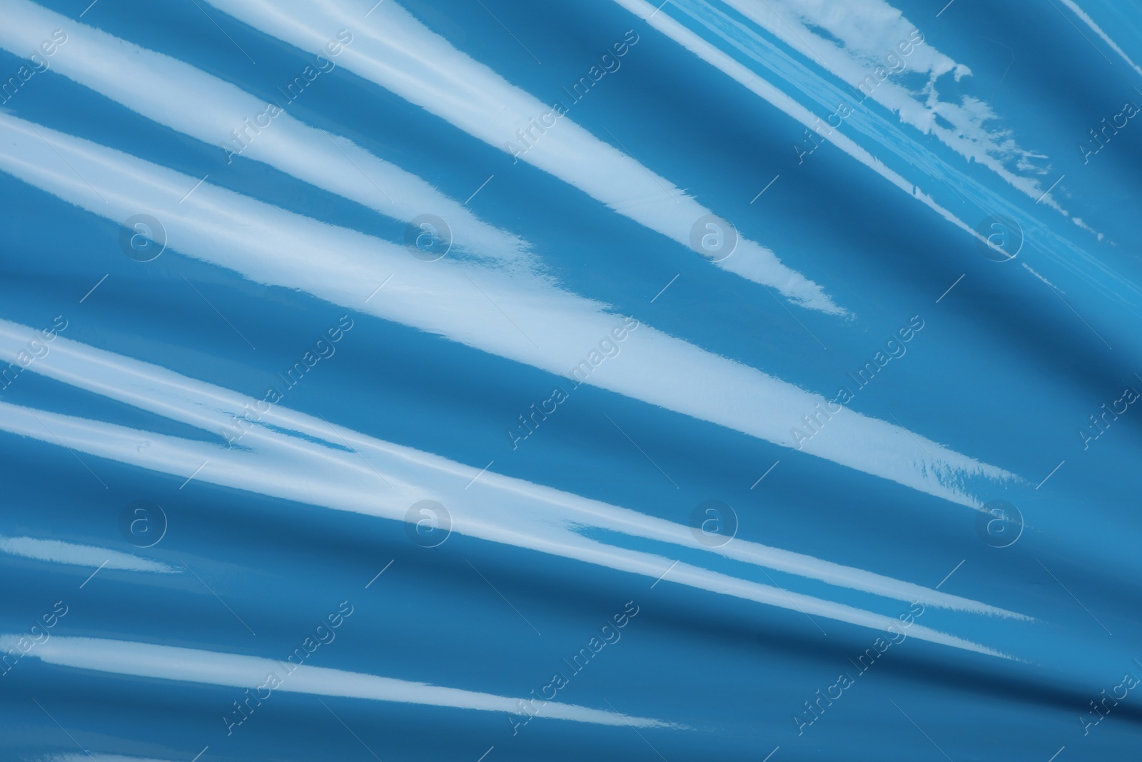 Photo of Light blue plastic stretch wrap film as background, top view