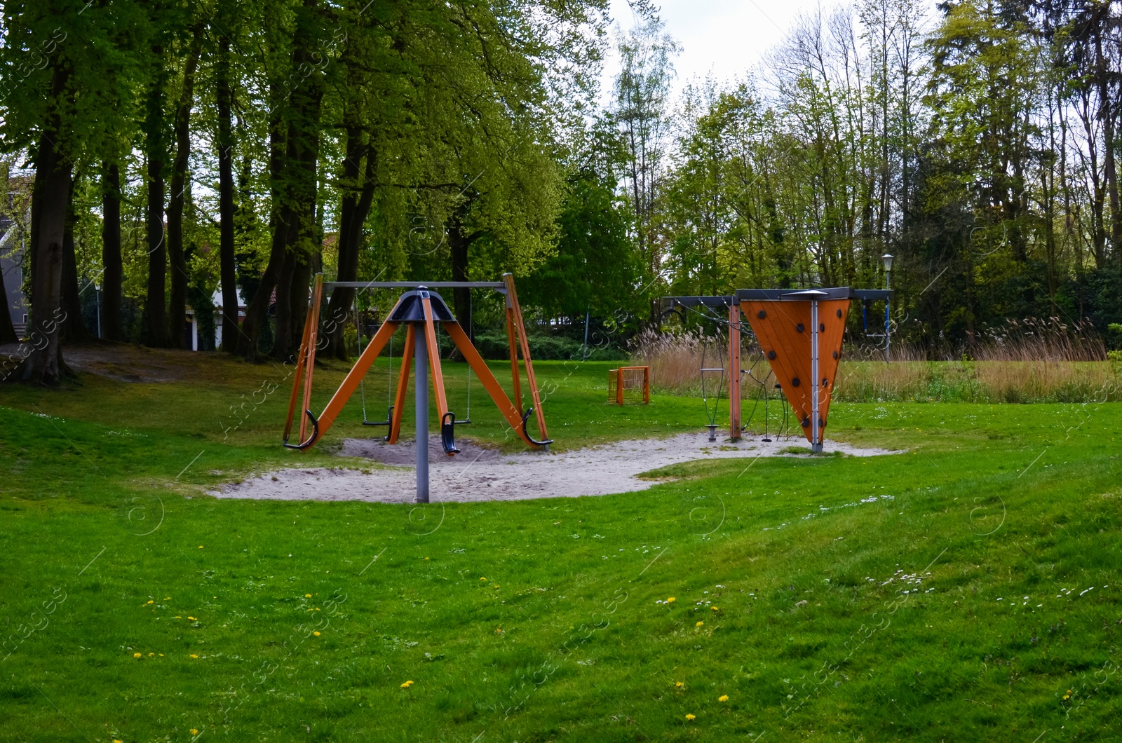 Photo of Beautiful green park with empty children's playground