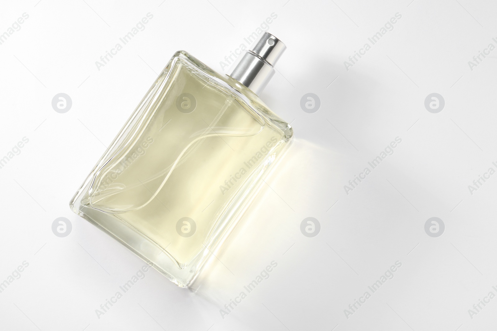 Photo of Luxury men`s perfume in bottle on white background, top view. Space for text