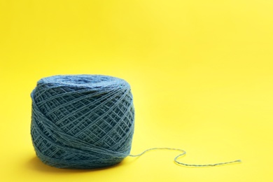 Clew of knitting threads on color background, space for text. Sewing stuff