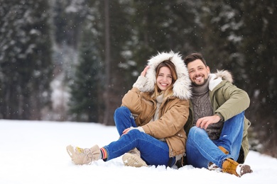 Photo of Couple spending time outdoors on snowy day. Winter vacation