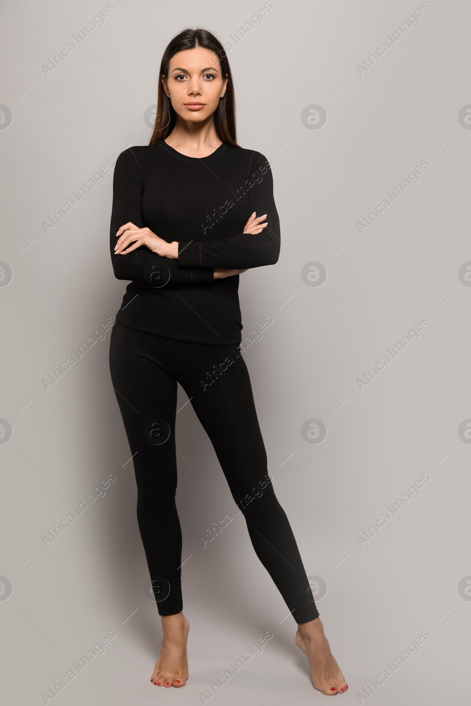 Photo of Woman wearing thermal underwear on grey background