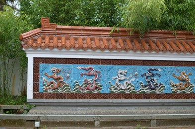 Photo of HAREN, NETHERLANDS - MAY 23, 2022: View of Nine-Dragon wall in Chinese garden