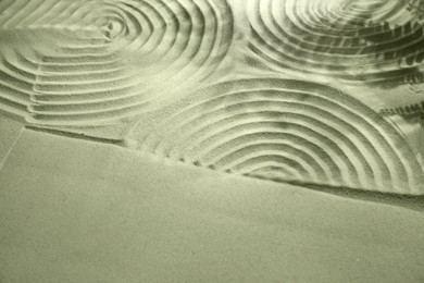 Photo of Beautiful patterns and shadowsleaves on sand, space for text. Zen garden