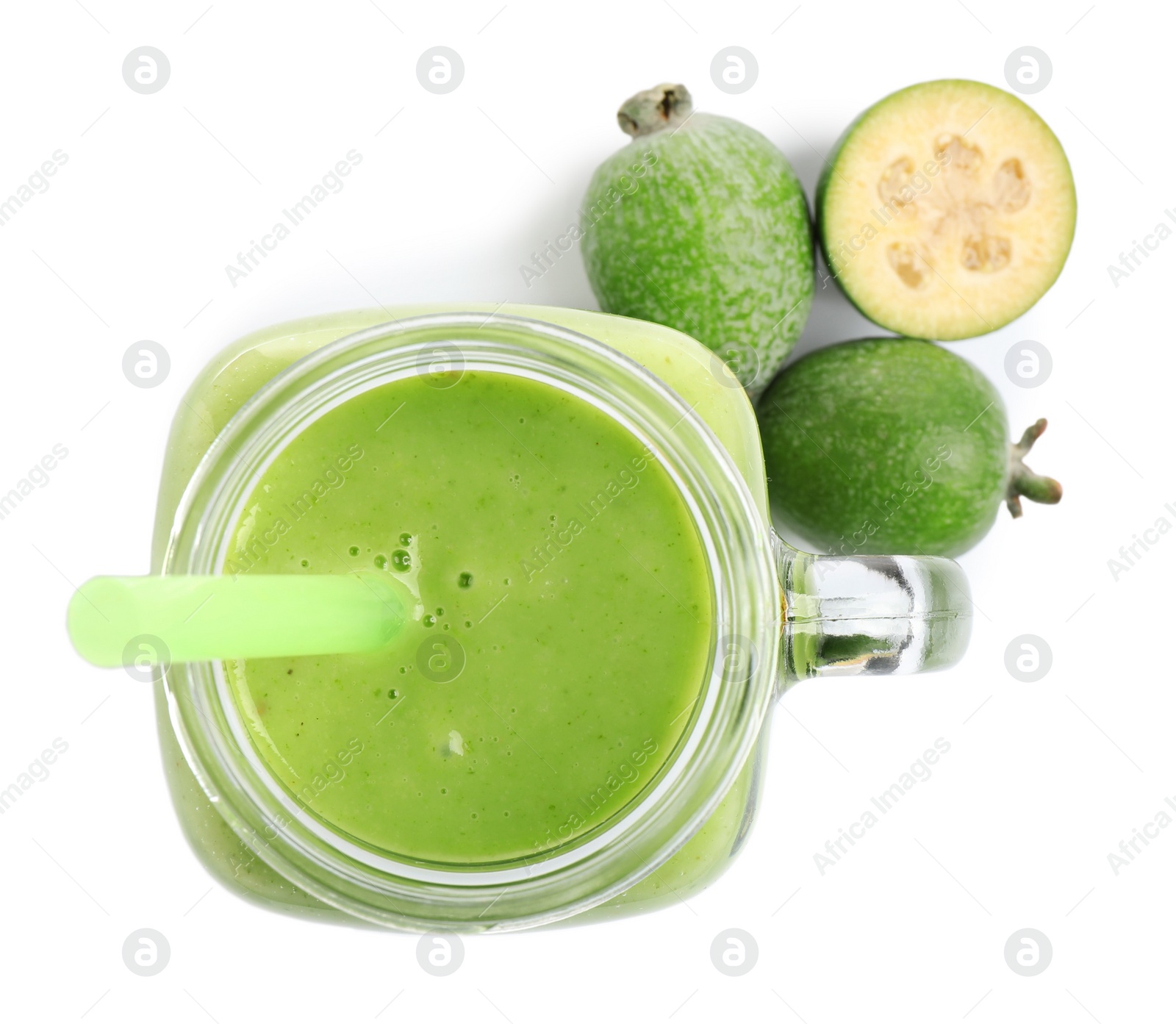 Photo of Fresh feijoa smoothie in mason jar and fresh fruits on white background, top view