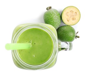 Fresh feijoa smoothie in mason jar and fresh fruits on white background, top view