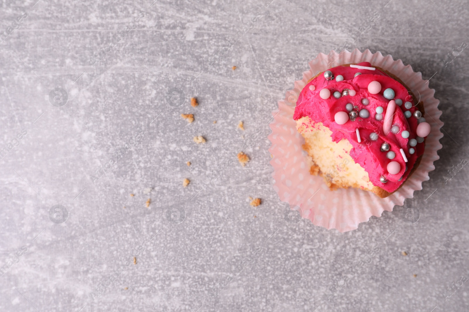 Photo of Failed cupcake and space for text on light grey table, top view. Troubles happen