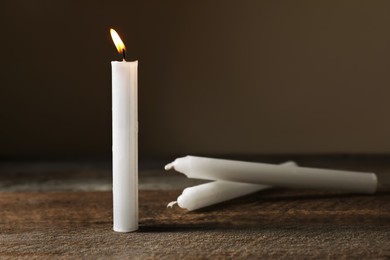 Church wax candles on dark background, space for text
