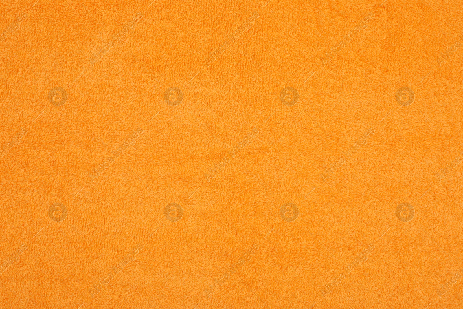 Photo of Orange beach towel as background, top view