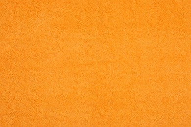 Photo of Orange beach towel as background, top view