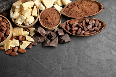 Flat lay composition with organic cocoa butter on black table. Space for text