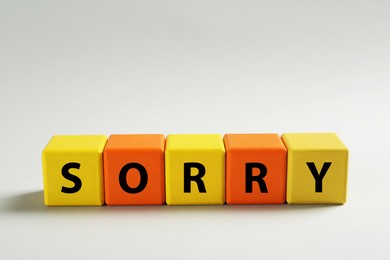 Image of Apology. Word Sorry made of colorful cubes on light background. Space for text