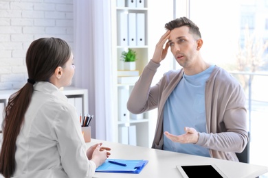 Photo of Female doctor consulting patient in clinic