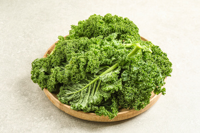 Photo of Fresh kale leaves on light grey table