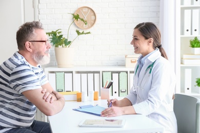 Photo of Female doctor consulting patient in clinic