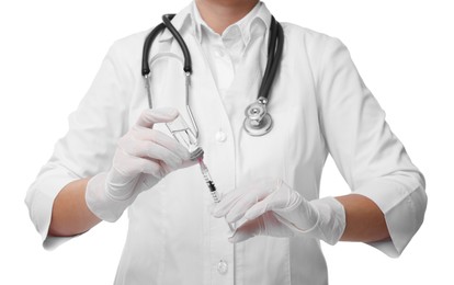 Doctor filling syringe with medication from glass vial on white background, closeup