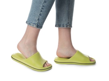 Woman in green slippers on white background, closeup
