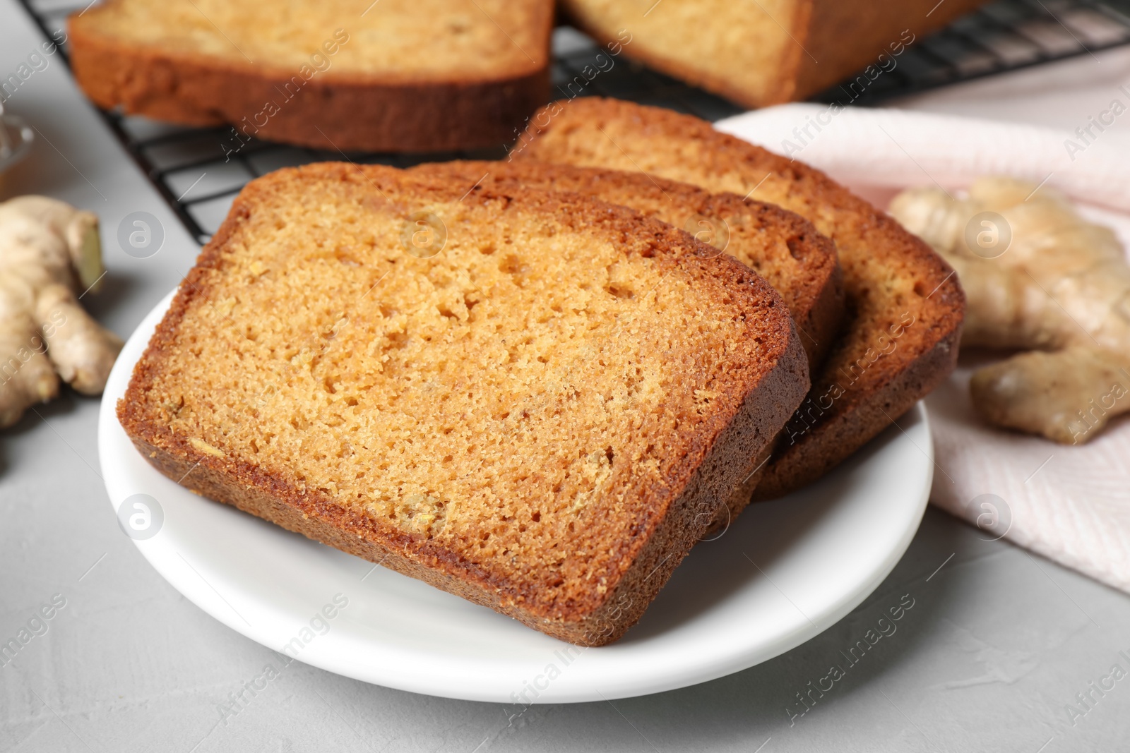 Photo of Fresh gingerbread cake slices served on light table, closeup