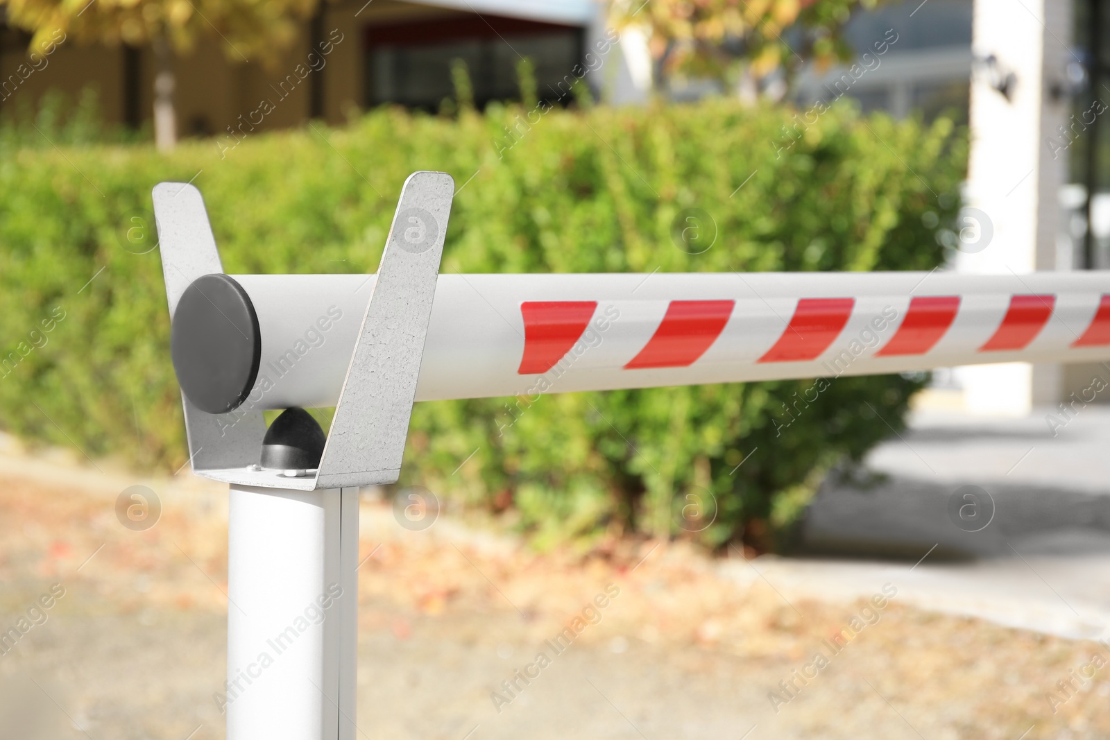 Photo of Closed automatic boom barrier on sunny day outdoors, closeup