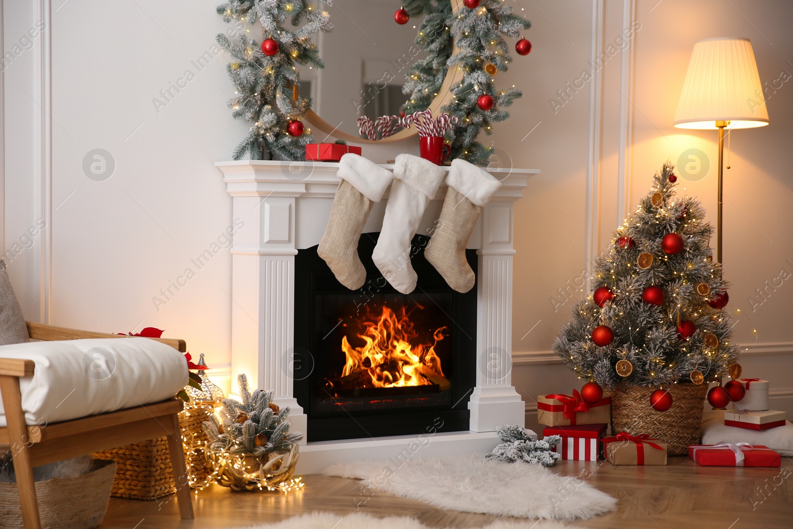 Photo of Fireplace with Christmas stockings in beautifully decorated living room