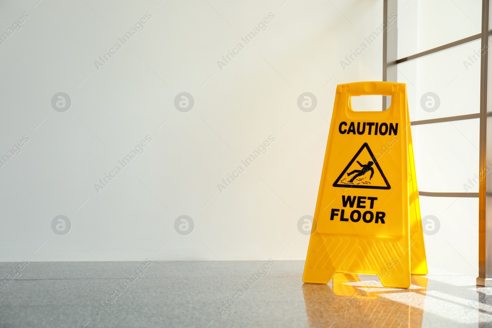 Photo of Safety sign with phrase Caution wet floor, indoors. Cleaning service