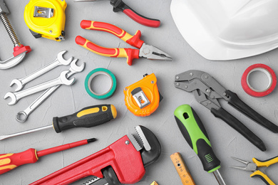 Photo of Flat lay composition with construction tools on light grey background