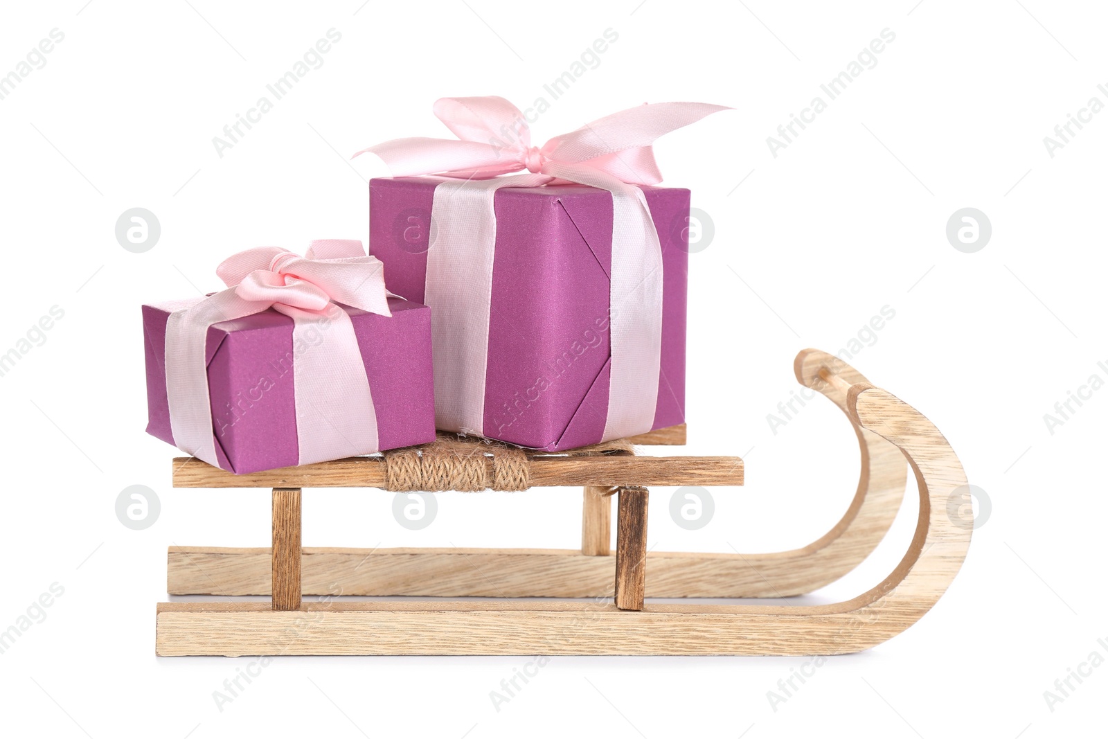 Photo of Wooden sleigh with presents on white background. Christmas holiday decor