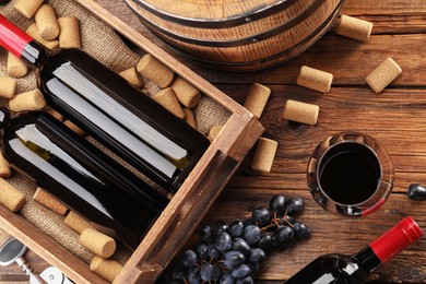 Photo of Winemaking. Flat lay composition with tasty wine and barrel on wooden table