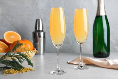 Photo of Glasses of Mimosa cocktail on light table