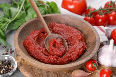 Tasty tomato paste and ingredients on table, closeup
