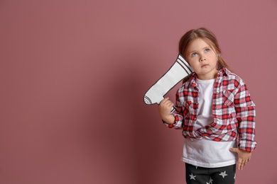 Photo of Adorable little girl with paper megaphone on color background