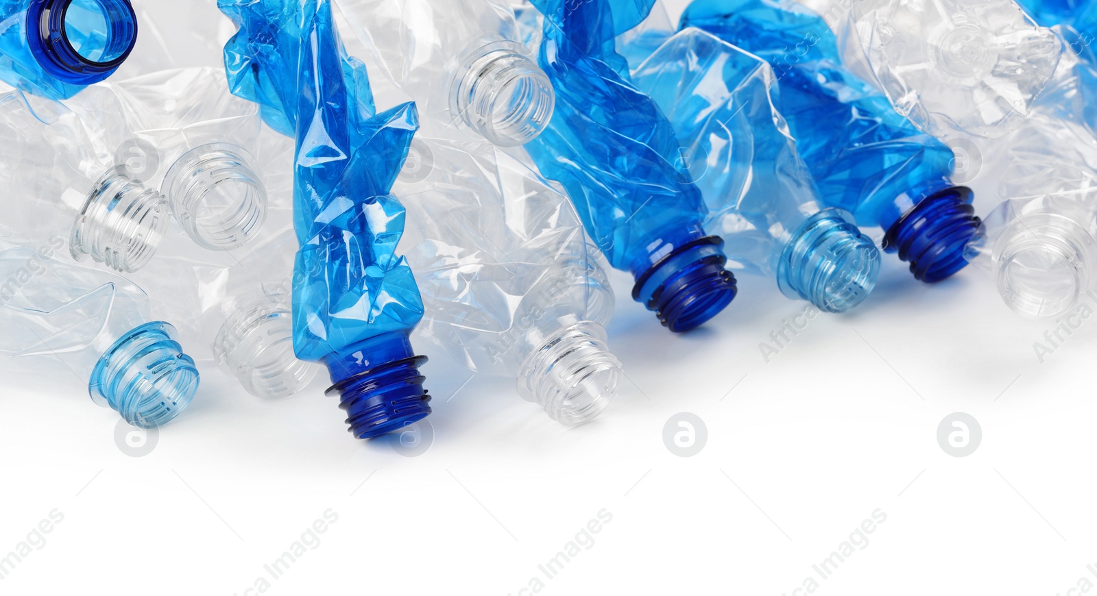 Photo of Crumpled disposable plastic bottles on white background, space for text