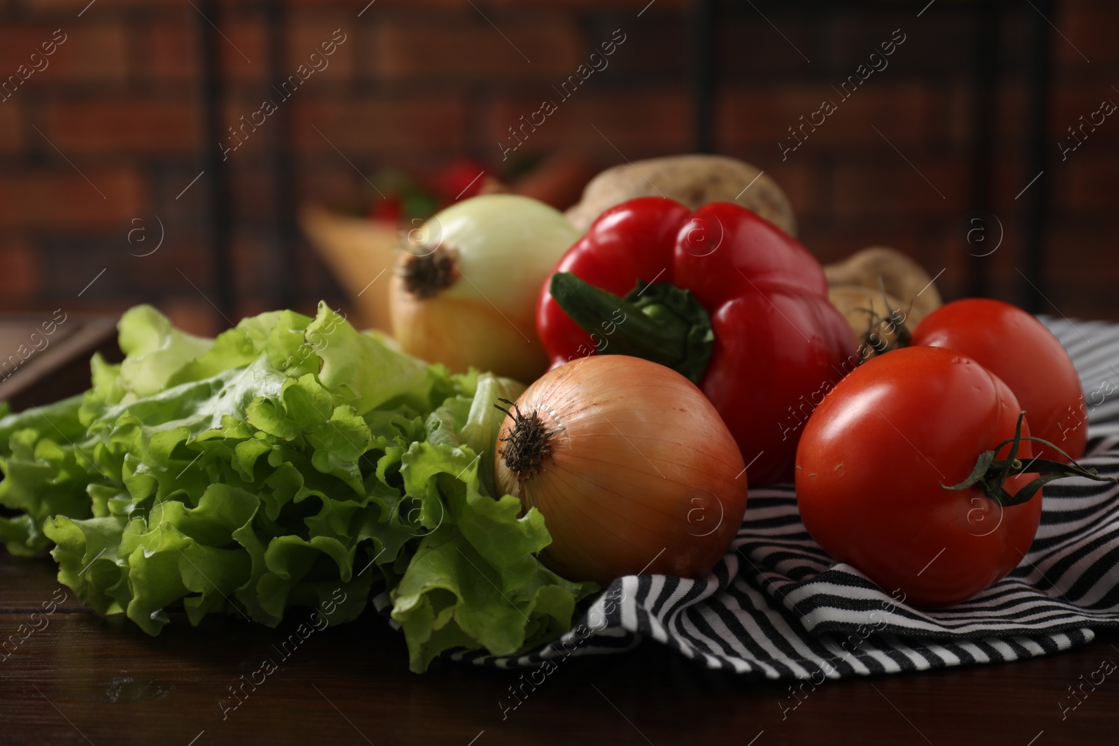 Photo of Different fresh vegetables on wooden table indoors