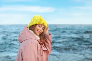 Portrait of beautiful young woman near sea