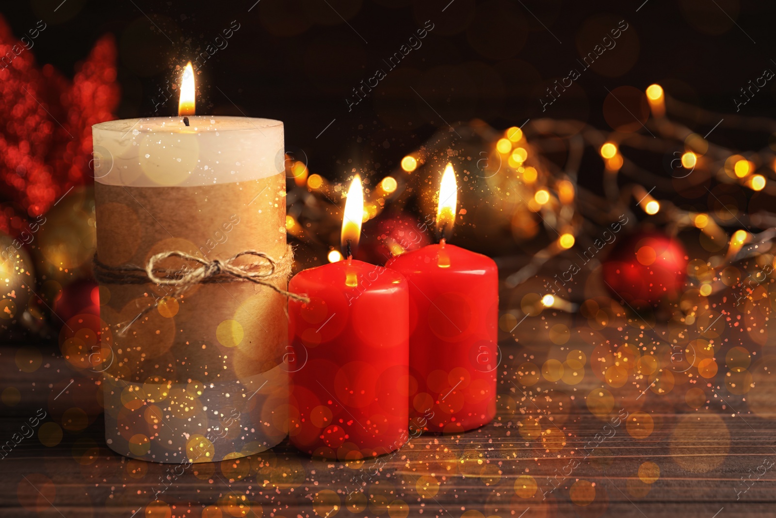 Image of Burning candles and Christmas decoration on wooden table, bokeh effect