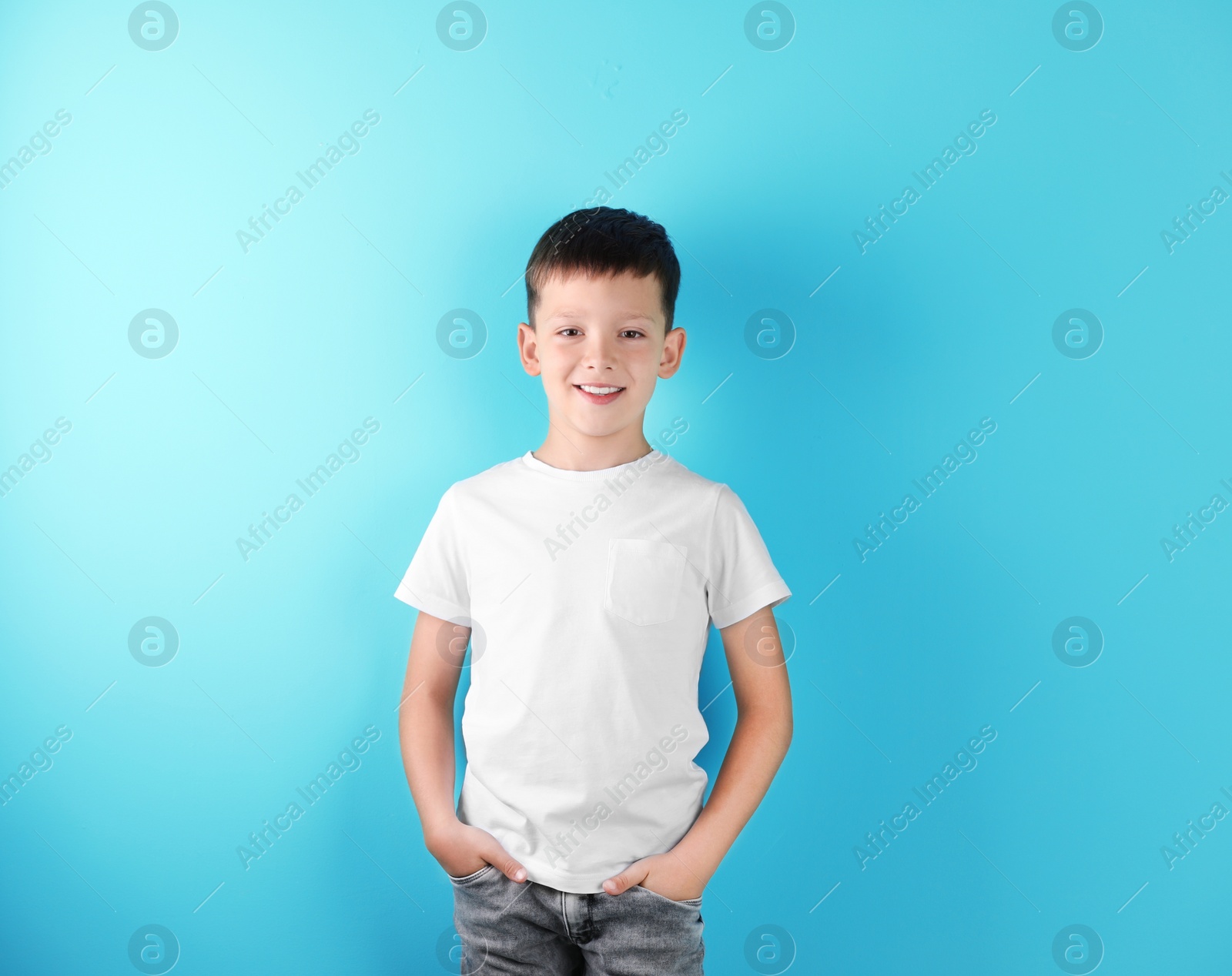 Photo of Little boy in t-shirt on color background. Mock-up for design