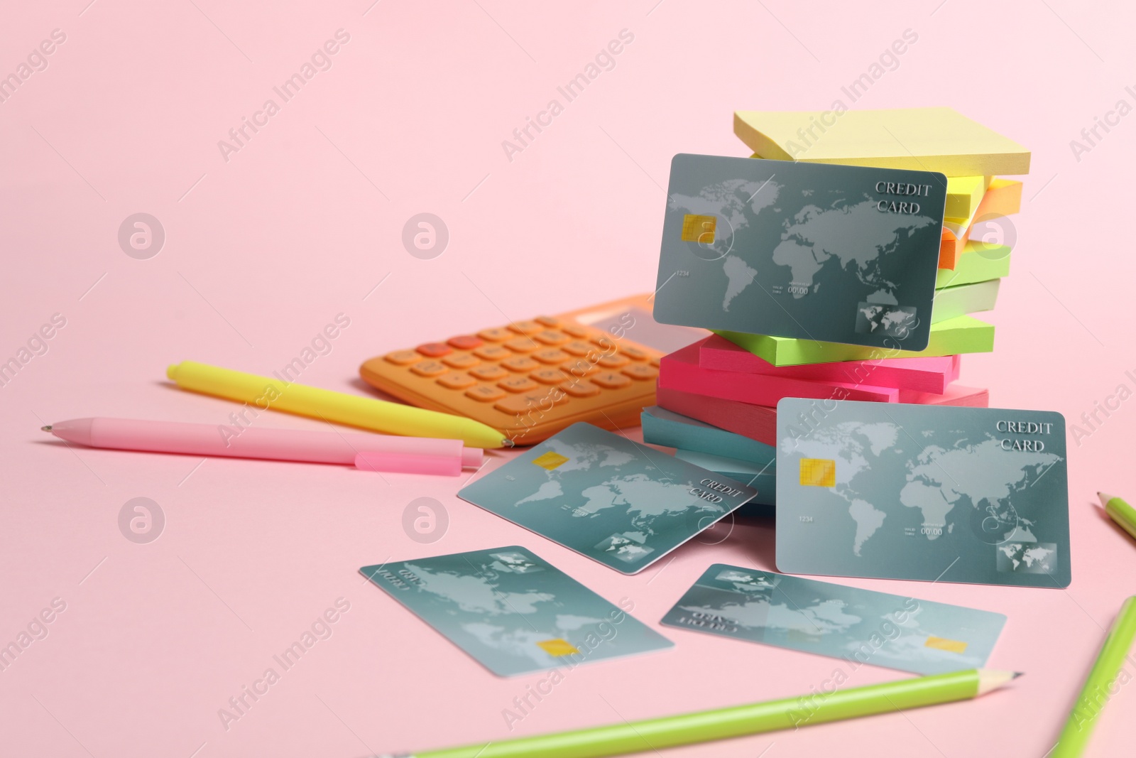 Photo of Credit cards and stationery on pink background