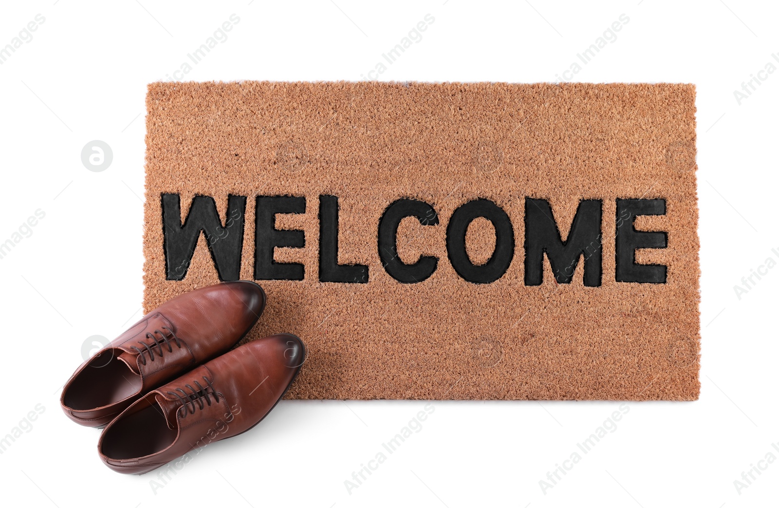 Photo of Stylish door mat with word Welcome and shoes on white background, top view