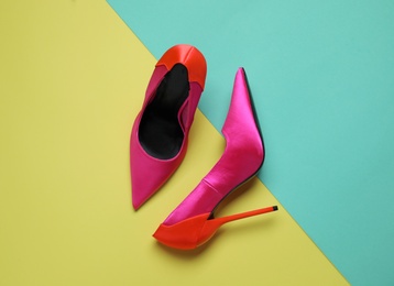 Photo of Pair of beautiful shoes on color background, top view