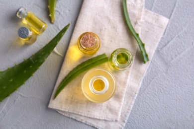 Bottles of aloe essential oil on table