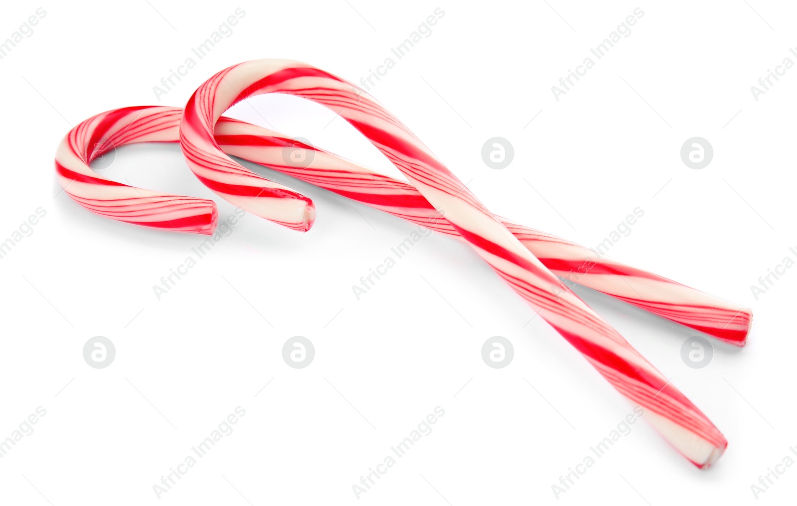 Photo of Tasty candy canes on white background. Festive treat