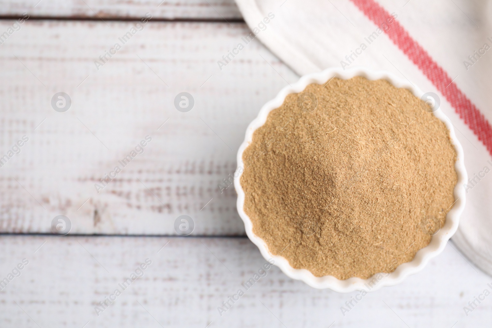 Photo of Dietary fiber. Psyllium husk powder in bowl on wooden table, top view. Space for text