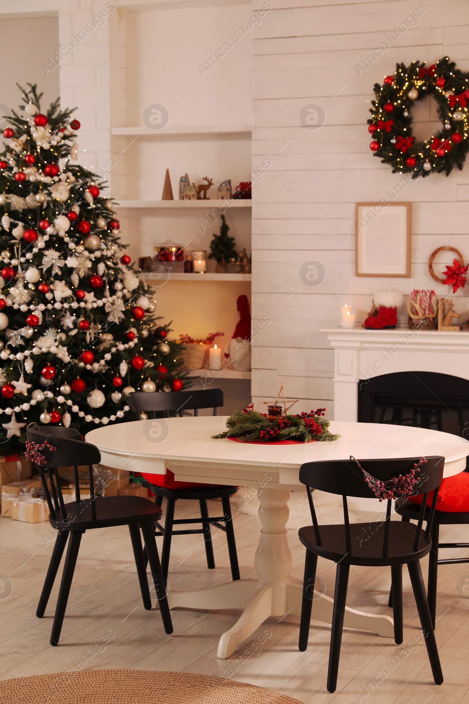 Photo of Cozy dining room interior with Christmas tree and festive decor