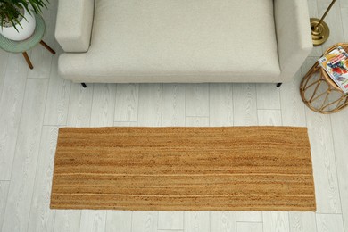 Photo of Stylish rug on floor in living room, top view
